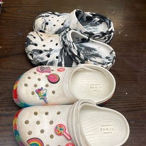 2 pair of girls crocs, all white. Black and white